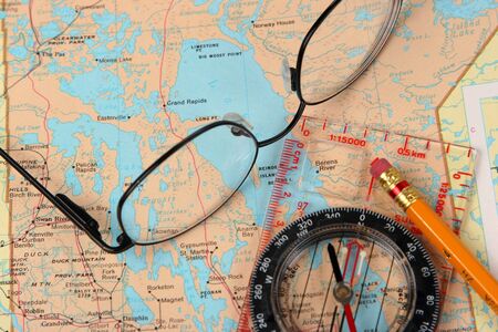 Glasses, map and compass