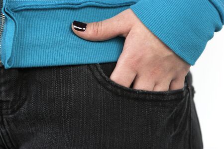 A girls hand in the front pocket of her black jeansの写真素材