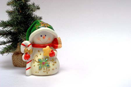 Christmas card with a snowman and christmas-treeの写真素材