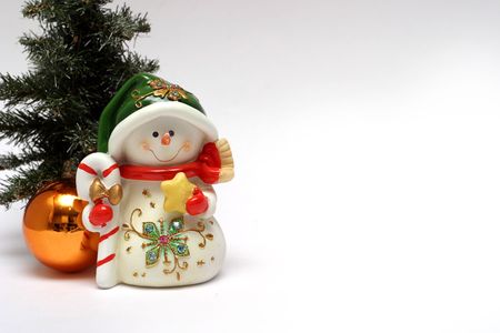 Christmas card with a snowman and christmas-tree decorationの写真素材