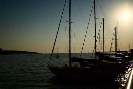 Silhouettes of marine yachts in the port.の写真素材