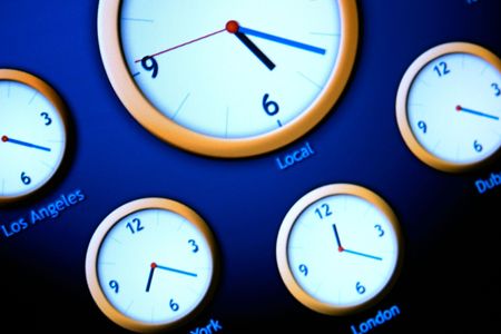 The clock shows the time in different cities around the worldの写真素材