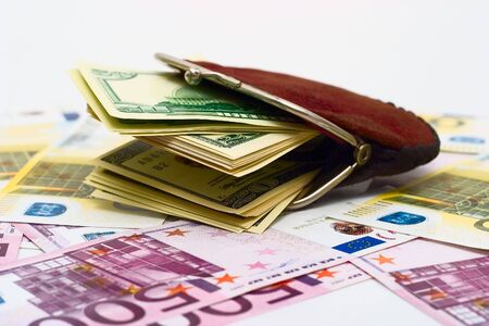 Purse full of dollars on a euro  backgroundの写真素材