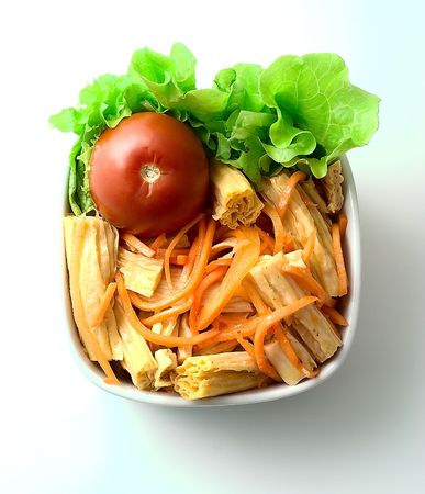 Korean salad with asparagus. Laying a green salad and marinated tomatoes.の写真素材