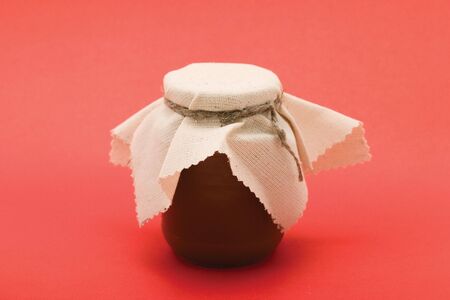 Honey jar on a red backgroundの写真素材
