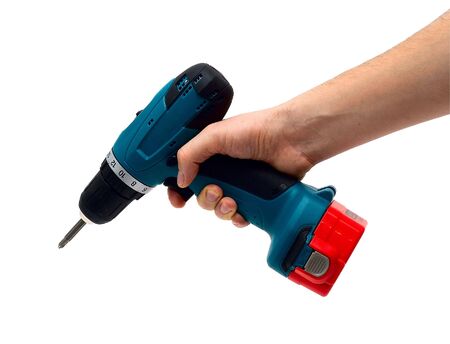 Repairman: the hand holds a drill-screwdriver. It is isolated on a white background.の写真素材