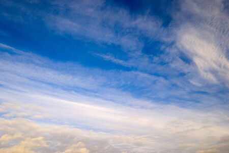 Natural photo of the sky, midday, winter, northern hemisphere. High plumose clouds are visible....