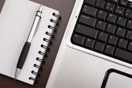 Working in the office: computer, papers and pen