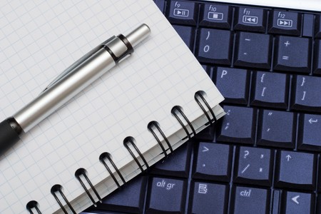 Business objects: pen, diary and a keyboard. Business background for any useの写真素材