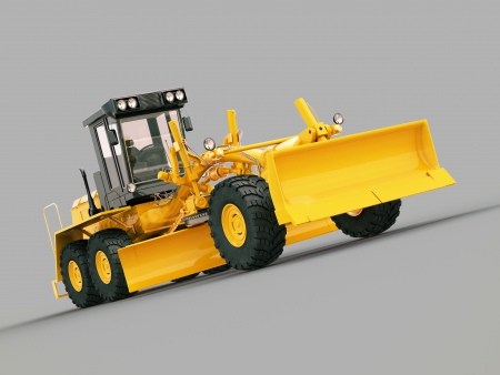 Modern three-axle road grader on a gray backgroundの写真素材