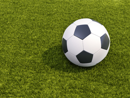 Soccer ball on grass with shadowの写真素材