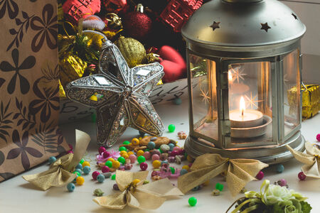 Christmas still life: lantern with burning candle and New Year tree decorations. Aperture 16の写真素材