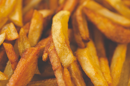 Golden French fries potatoes ready to be eaten. Slightly overcooked, that would be crispyの写真素材