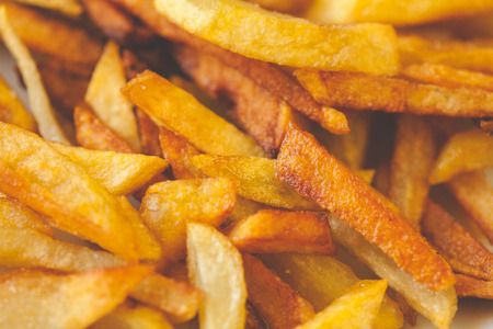 Golden French fries potatoes ready to be eaten. Slightly overcooked, that would be crispyの写真素材