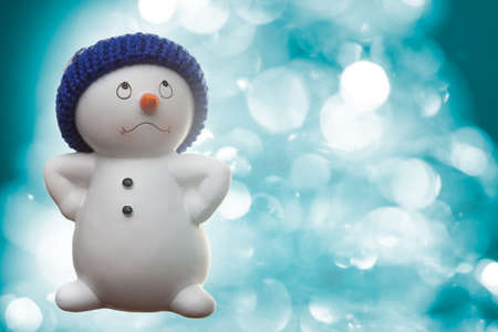 Cheerful snowman on bluerred winter backgroundの写真素材