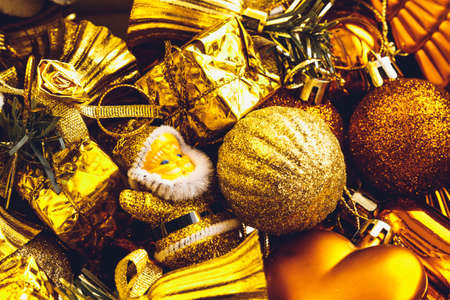 Christmas decorations box with stars, toys and ornaments. Golden baubles and ribbonsの写真素材