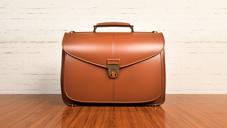 Closeup of fashionable leather briefcase on hardwood tableの写真素材