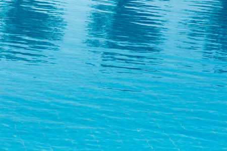 Hotel swimming pool with sunny reflections