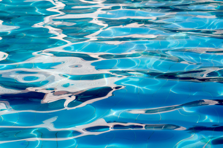 Hotel swimming pool with sunny reflectionsの写真素材