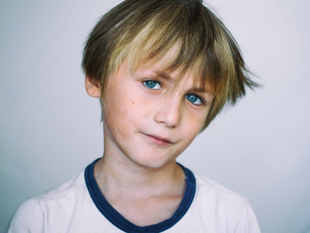 Boy 9 years old in front of a light  background, close-up