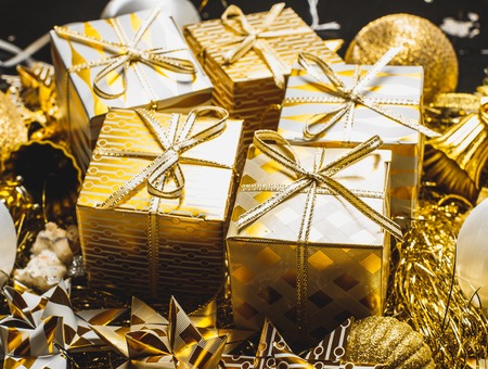 Decorated Golden Christmas Gifts Box Presents with Gold and White Ribbon, Many Christmas Presents Boxes With Twine And Decorations On A Table, Xmas boxes With Bows, Christmas Card Poster Banner.の写真素材