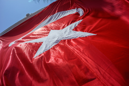 Close up Waving Fabric Flag of Turkey, Turkish National Flag Fabric Background Texture, Turkey Flag Blowing in the Wind, Realistic Flag of Turkey on Wavy Surface of Fabric, Fluttering Downwindの写真素材