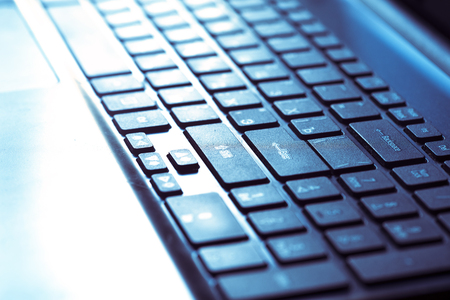 Perspective of Black Illuminated Laptop Keyboard, Russian Hacker Hacking the Server in the Dark, Abstract Image of Backlit Keyboard Computer Detail, E-Technology, On-line Business or Education Conceptの写真素材