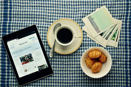 Opened book with and cup of coffeeの写真素材