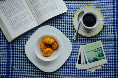 Opened book with and cup of coffeeの写真素材