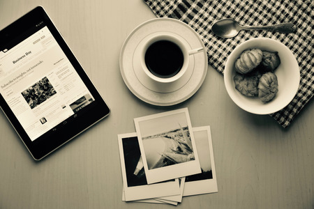 Coffee break in morning. Reading the news.の写真素材