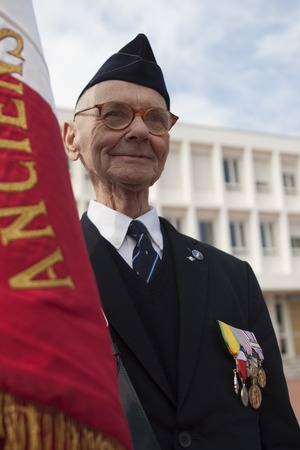 Aubagne, France. May 11, 2012. Portrait of a veteran of the French foreign legion with the banner of veterans .のeditorial素材