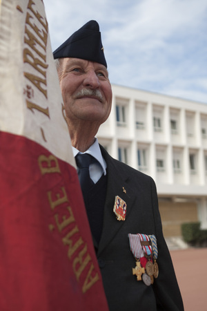 Aubagne, France. May 11, 2012. Portrait of a veteran of the French foreign legion in a jacket with military medals with the banner of veterans during the annual meeting of veterans.のeditorial素材
