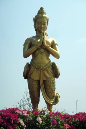 Golden Thai statue in the blue bacgroundの写真素材