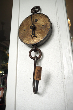 The Old  scales hanging on the white wallの写真素材
