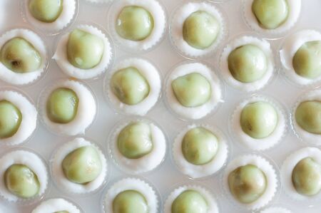 Steamed Flour with Coconut Filling little cup with foam plate background, Kanom Sai Saiの写真素材