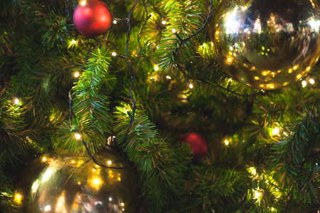 Close up big yellow glitter ball christmas on tree with wire white light backgroundの写真素材