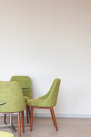Close up green chair modern style on white concrete corner backgroundの写真素材