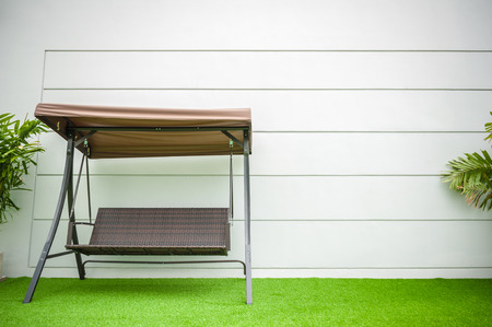 Steel brown swing chair modern style on white concrete background