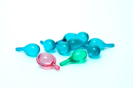 Vitamin serum capsule with a white background.の写真素材