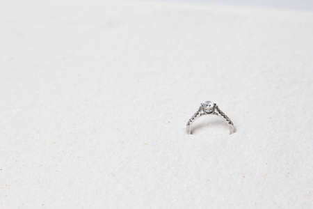 Wedding ring on white sand.の写真素材