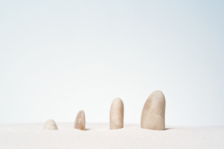Stones stacked on the sand background.の写真素材