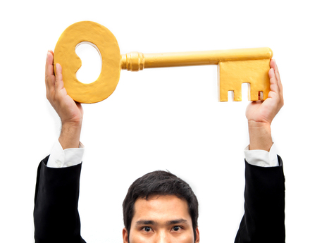 Businessman holding a key in the hands.の写真素材