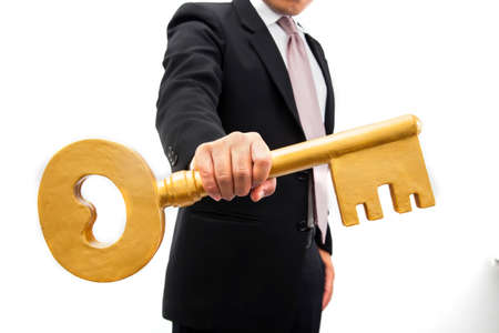 Businessman holding a key in the hands.の写真素材