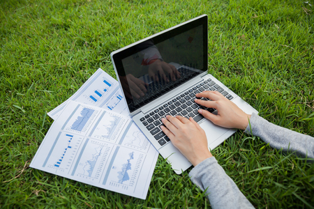 The woman checking reported profits in the garden.の写真素材