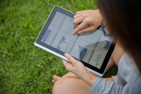 The woman checking reported profits in the garden.の写真素材