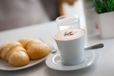 Hot coffee and bread on table.の写真素材