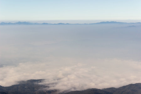 Nature on mountain peaks with mist overlay