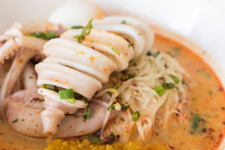 Asian spicy noodle with squid, Tom yum noodle soup, spicy thai foodの写真素材