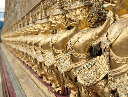 Row of golden garuda statues in temple, Bangkok, Thailandの写真素材