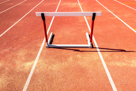 hurdle race barrier on red  running track , athletic stadiumの写真素材